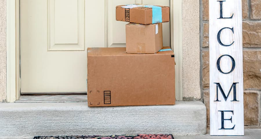 Boxes by the door of a residence with a welcome sign in Hoover